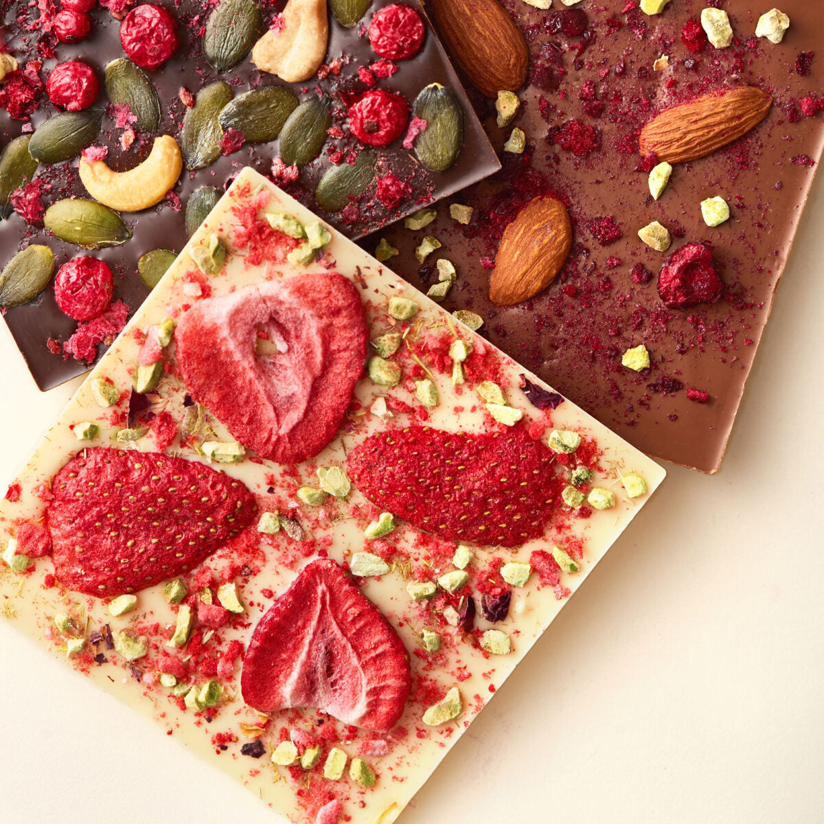 Different types of no-sugar chocolates with fruits, nuts and seeds